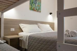 a bedroom with a bed and a table with towels at Villa Ella by Interlux in Rimini