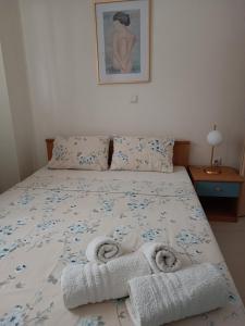 a bedroom with a bed with towels on it at 3 min from central station No2 private free parking in Thessaloniki