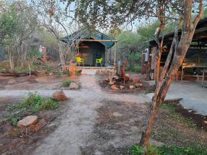 a small building in the middle of a yard at Aloes Rest Camp in Marloth Park