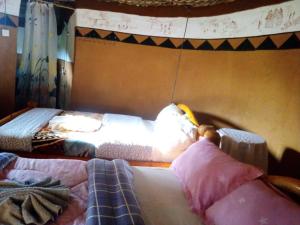 two beds sitting in a room with at Rock garden Sipi in Kapchorwa
