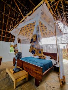 a bedroom with a canopy bed with a swing at Pangani Cliffs Lodge in Pangani