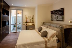 a bedroom with a large bed and a fireplace at Maison d'Or in Genoa