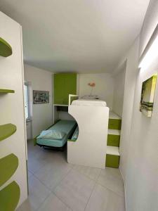a small room with a bed and a white cabinet at Appartamento all ‘Argentario Porto Santostefano Gr in Porto Santo Stefano