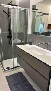 a bathroom with a sink and a shower at Appartamento all ‘Argentario Porto Santostefano Gr in Porto Santo Stefano