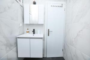 a white bathroom with a sink and a shower at Casa San Pierro in Corfu +21 photos