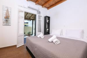 a bedroom with a large bed with towels on it at Casa San Pierro in Corfu
