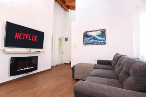 a living room with a couch and a tv at Casa San Pierro in Corfu