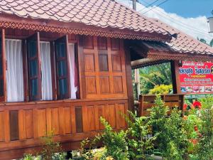 a small wooden house with a sign on it at KOB SUK RESORT k7 , k10 in Sichon