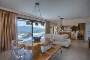 a living room with a table and a couch at Armante Supreme Villas-Villa Nicole in Fternón