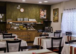 a dining room with tables and chairs and a counter at Arpini Hotel in Rio Grande