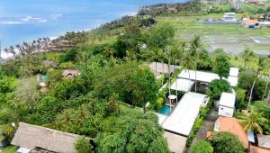 an aerial view of a house with trees and the ocean at Amazing 3BDR-Villa Canggu/Seseh 2min walk to Beach in Canggu