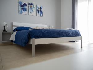 1 dormitorio con 1 cama con edredón azul en Dino's Rooms, en Lioni