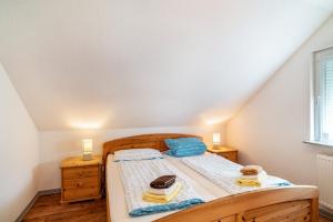 a bedroom with a bed with two towels on it at Schwalbenhof Dreßler und Duss für 2 Personen in Bad Herrenalb