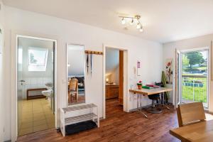 a living room with a table and a mirror at Schwalbenhof Dreßler und Duss für 2 Personen in Bad Herrenalb