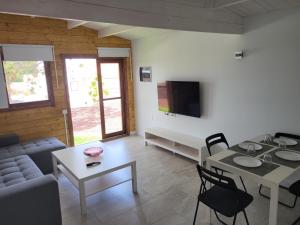 a living room with a couch and a table at Preciosa cabaña in Guía de Isora +8 photos