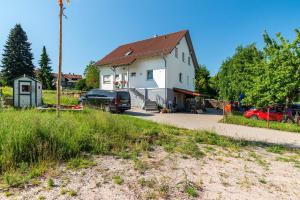 a house with a truck parked in front of it at Schwalbenhof Dreßler und Duss für 4 Personen in Bad Herrenalb