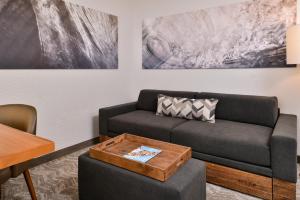 a living room with a couch and a table at SpringHill Suites Irvine John Wayne Airport / Orange County in Irvine