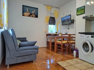a living room with a kitchen and a dining room at Apartments Jessica in Krk