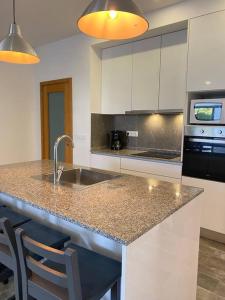 a kitchen with a sink and a stove top oven at Apartamento em braga in Braga
