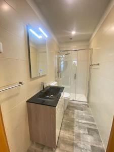 a bathroom with a sink and a toilet at Apartamento em braga in Braga