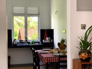 a dining room with a table and a window at Villa Avi - Near Airport in Negombo