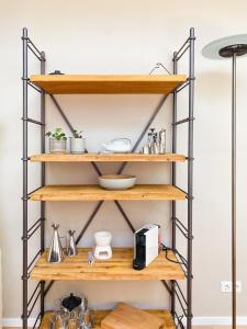 a shelf in a kitchen with wood and metal shelving at Lovely studio in Oud-Beijerland in Oud-Beijerland