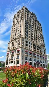 a tall building with red flowers in front of it at Burgas Residence 809 in Burgas City