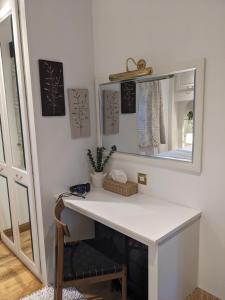 a bathroom with a white counter and a mirror at Heather Cottage Luss in Luss