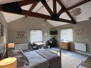a bedroom with a bed and a desk in a room at White House Farm - Beautiful Self Contained Courtyard Rooms in Whitby