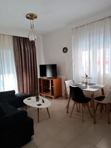 a living room with a couch and a table at 3 min from central station No2 private free parking in Thessaloniki