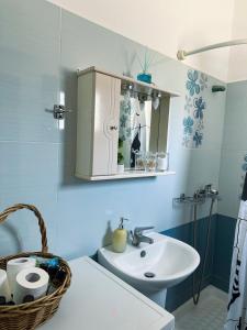 a bathroom with a sink and a mirror at Leros Sunset Apartments in Gourna