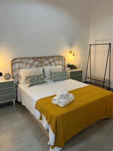 a bedroom with a large bed with towels on it at Apartamentos La Chimenea in Merida