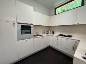 a white kitchen with white cabinets and a window at Camogli - "Casa Oliver" - Liguria Holidays in Camogli