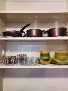 two pots and pans on a shelf in a kitchen at Port Golf Marina Families Only in El Alamein +33 photos