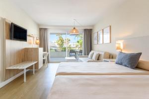 a hotel room with a large bed and a television at FERGUS Club Palmanova Park in Palmanova +51 photos
