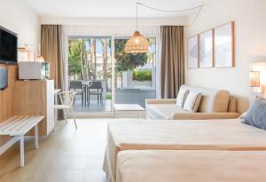 a hotel room with a bed and a living room at FERGUS Club Palmanova Park in Palmanova