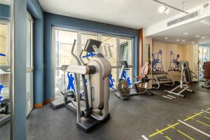 a gym with several treadmills and exercise machines at Hotel Rossini Al Teatro in Imperia