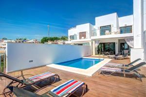 a villa with a swimming pool and chairs on a balcony at Villa Luisa Seaview 3 Casasol in Torrox Costa