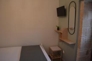a bedroom with a bed and a tv on the wall at Lily's studio in Vathí
