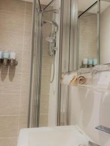 a bathroom with a shower and a mirror at THE PAD by the beach Penthouse apartment with sunset and city views in Bournemouth