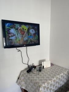 uma televisão de ecrã plano numa parede por cima de uma mesa em PROMO Appartement Familial avec WiFi em Al Hoceïma