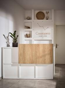 a white table in a room with a wooden counter at Cassiopeia Rooms & Suites in Laganas