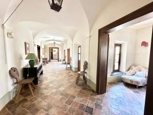 een hal met een kamer met een bank en een tafel bij Incredible experience in an ancient Convent from the 1200s in Ginestra