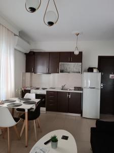 a kitchen with a white refrigerator and a table at 3 min from central station No2 private free parking in Thessaloniki