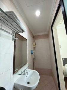 een badkamer met een wastafel en een spiegel bij Amrise Hotel in Singapore