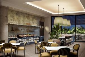 a restaurant with tables and chairs and a buffet at Istanbul Marriott Hotel Pendik in Istanbul