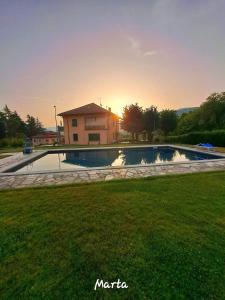 a swimming pool in front of a house at Villa Costanza in Bobbio