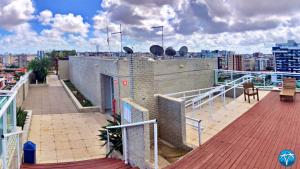 a balcony of a building with a view of a city at Vacanze - Austrália (JTR) in Maceió