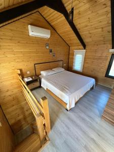a bedroom with a bed in a wooden room at Lake House Kayacık in Dalaman