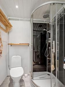 a bathroom with a toilet and a glass shower at Embracing nature's Swedish house in Ludvika